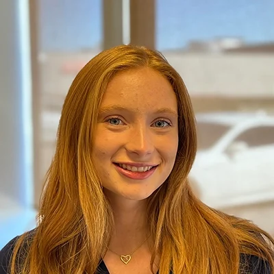 Staff Member Lizzy Baker Smiling In Office