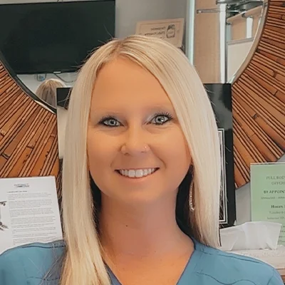 Staff Member Tabatha Perkins Smiling In Office