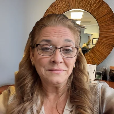 Staff Member Teresa Blevins Smiling In Office